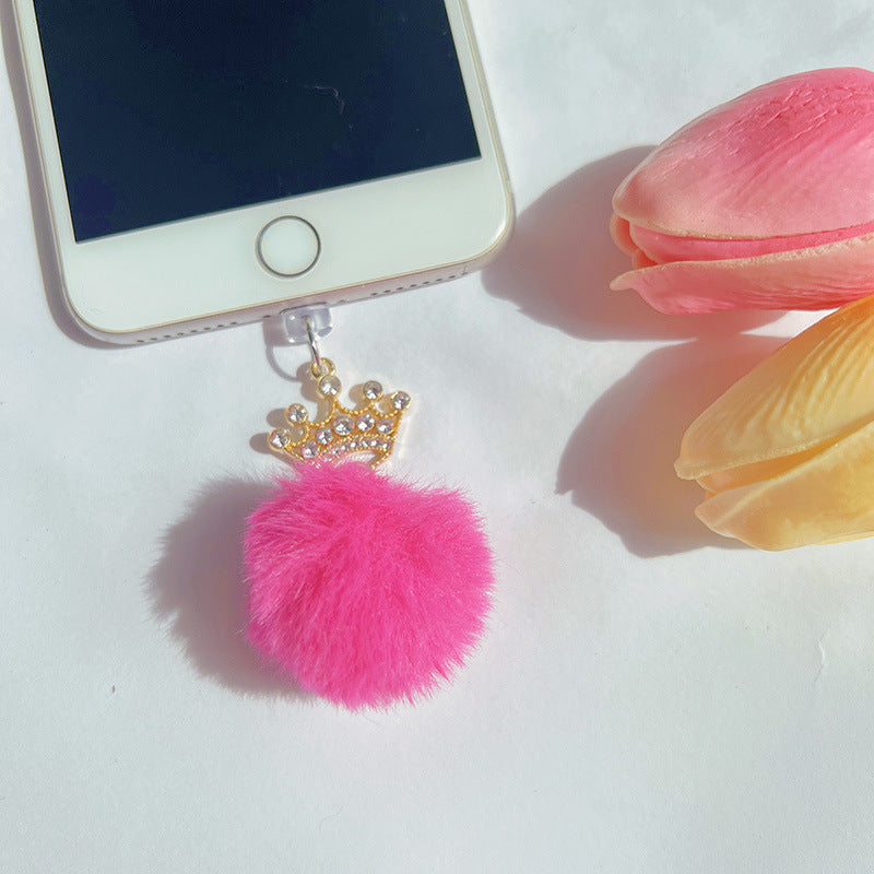 Phone charm with fluffy ball and cartoon crown design