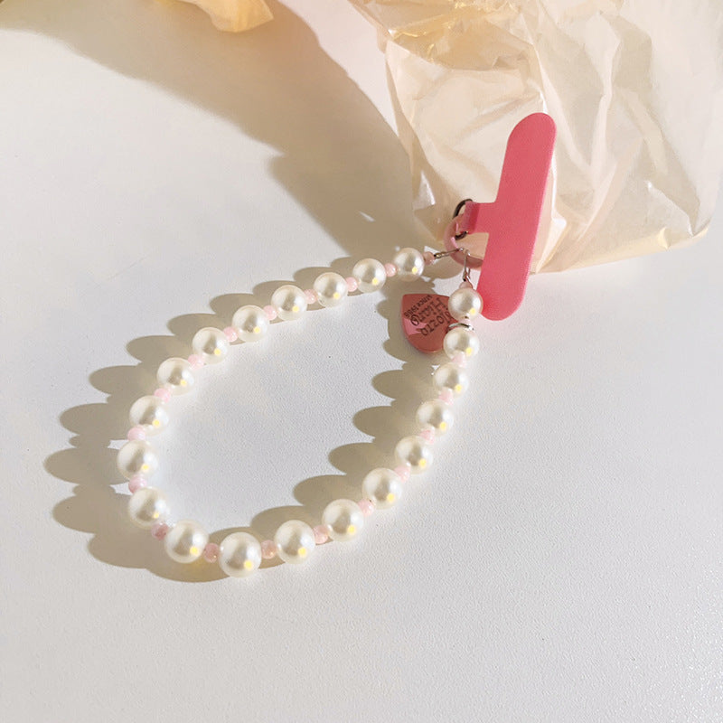 Phone strap holder featuring beaded pink and pearl design