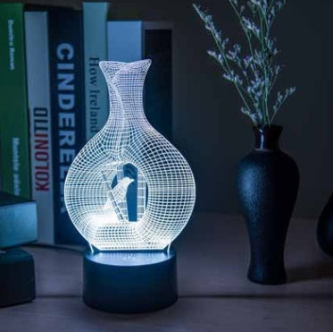 3D LED night light with bird vase design on desk